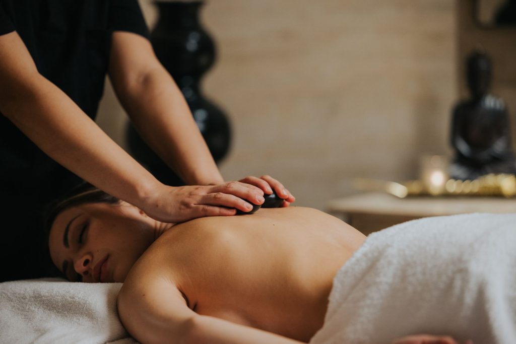 woman enjoying a hot stone massage at Xemxija Bay Hotel in Malta